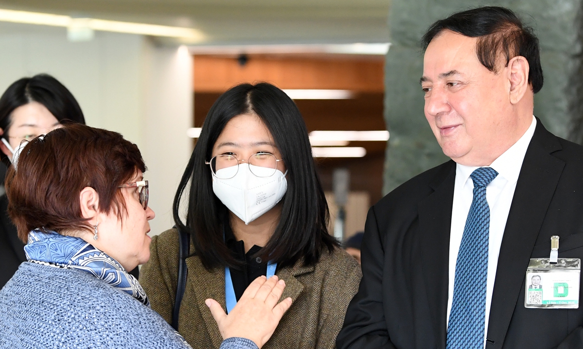Shewket Imin, director of the Standing Committee of the People's Congress of Xinjiang Uygur Autonomous Region, interacts with diplomats attending the ceremony of the photo exhibition entitled 