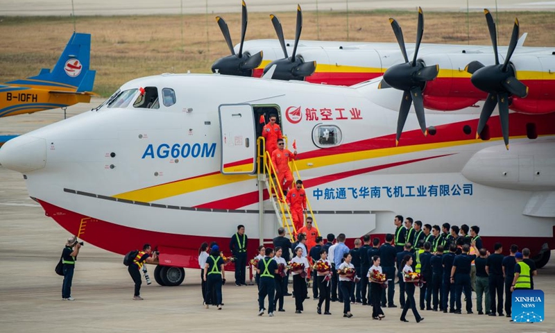 Crew members of an AG600M firefighting aircraft disembark from the plane after a gathering and dropping water test in Jingmen, central China's Hubei Province, Sept. 27, 2022. Codenamed Kunlong, the AG600 large amphibious aircraft family is seen as key aeronautical equipment for China's emergency-rescue system. It was developed by the Aviation Industry Corporation of China (AVIC), the country's leading plane-maker, to meet the needs of firefighting and marine-rescue missions, as well as other critical emergency-rescue operations.(Photo: Xinhua)