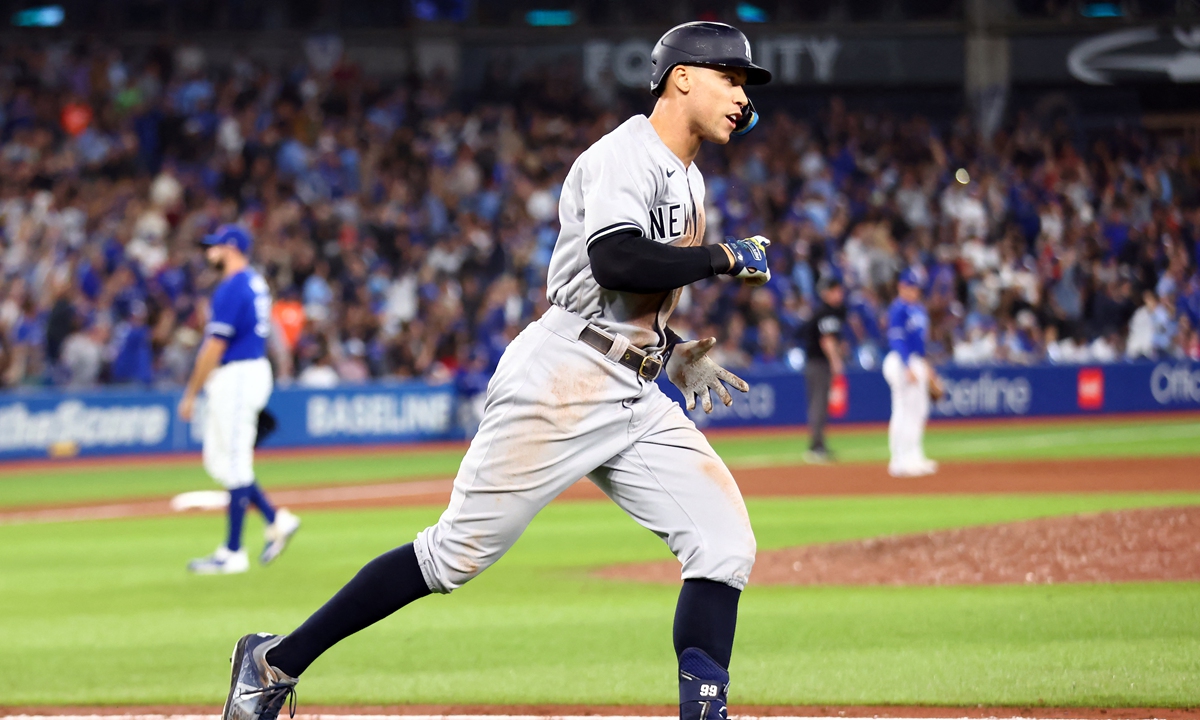 Aaron Judge of the New York Yankees celebrates after hitting his 61st home run of the season in the seventh inning against the Toronto Blue Jays at Rogers Centre in Toronto, Ontario, Canada on September 28, 2022. Photo: AFP