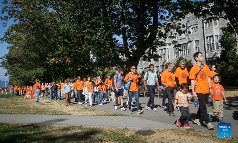 People wearing orange T-shirts attend an event to commemorate the National Day for Truth and Reconciliation at University of British Columbia in Vancouver, Canada, on Sept. 30, 2022. Canada marked the second National Day for Truth and Reconciliation on Friday, reflecting about the tragedy of residential schools. (Photo by Liang Sen/Xinhua)