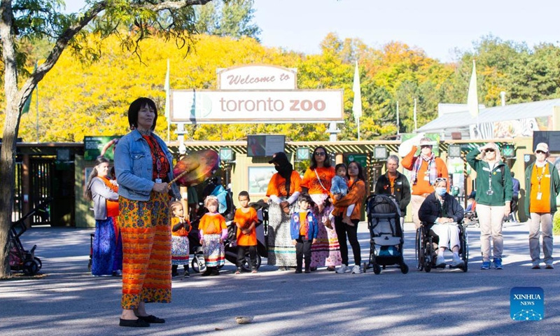 An indigenous woman performs at a commemoration during the National Day for Truth and Reconciliation in Toronto, Canada, on Sept. 30, 2022. Canada marked its second National Day for Truth and Reconciliation on Friday to honor lost children and survivors of the notorious indigenous residential school system in the country. (Photo by Zou Zheng/Xinhua)