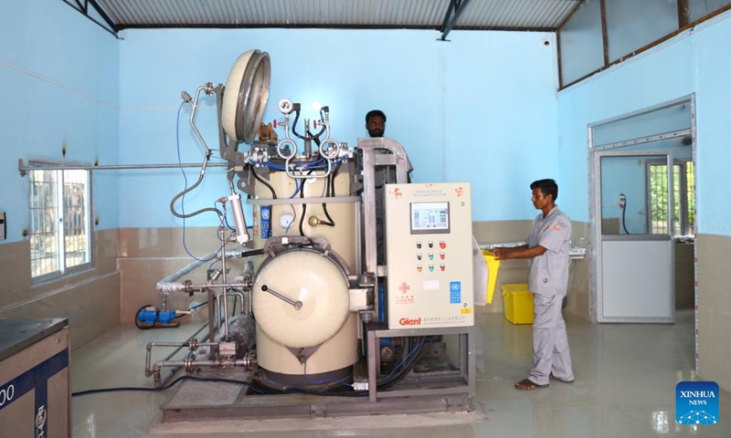 Workers operate machines at a China-funded waste treatment center in Narayani Hospital in Birgunj, Nepal, Sept. 29, 2022. Narayani Hospital in Nepal's southern city of Birgunj has its own health care waste treatment center now, bringing much relief to those inside and around the health facility. (Photo by Hari Maharjan/Xinhua)