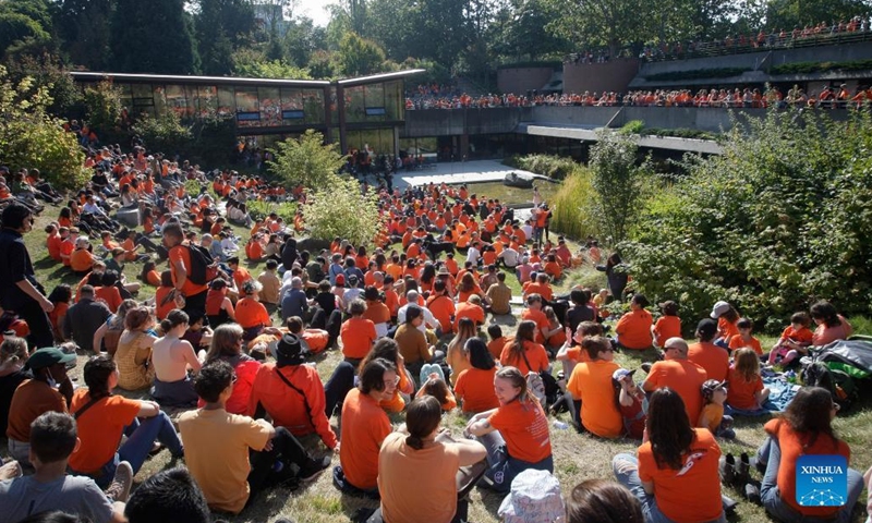 People wearing orange T-shirts attend an event to commemorate the National Day for Truth and Reconciliation at University of British Columbia in Vancouver, Canada, on Sept. 30, 2022. Canada marked the second National Day for Truth and Reconciliation on Friday, reflecting about the tragedy of residential schools. (Photo by Liang Sen/Xinhua)