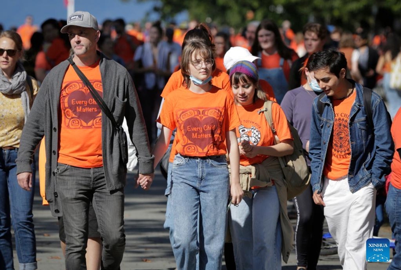 People wearing orange T-shirts attend an event to commemorate the National Day for Truth and Reconciliation at University of British Columbia in Vancouver, Canada, on Sept. 30, 2022. Canada marked the second National Day for Truth and Reconciliation on Friday, reflecting about the tragedy of residential schools. (Photo by Liang Sen/Xinhua)