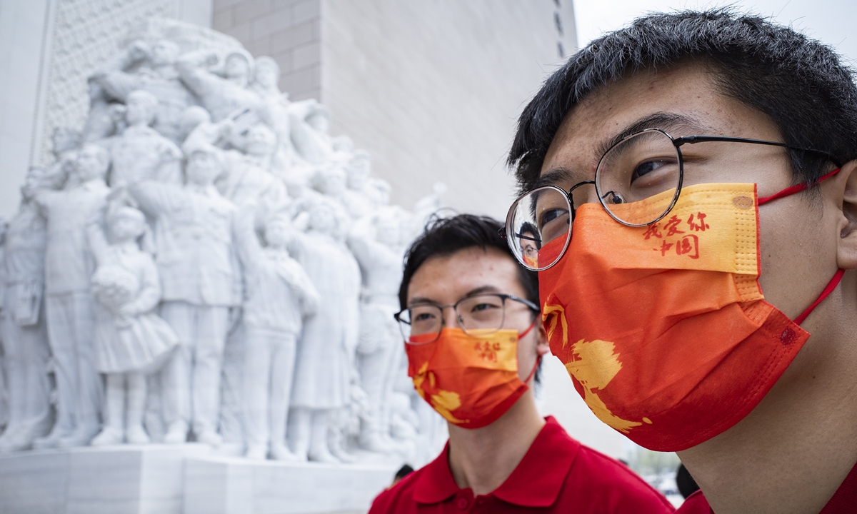 Two Chinese youngsters visit the Museum of the Communist Party of China in Beijing on October 1, 2022. Photo: VCG