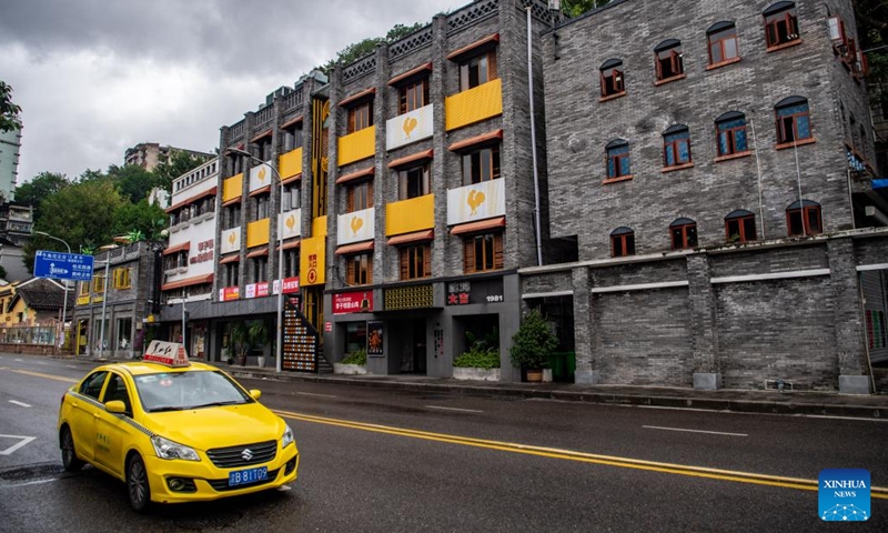 A taxi is seen outside a commercial complex reconstructed from an old building in Yuzhong District, southwest China's Chongqing, Oct. 6, 2022.Photo:Xinhua