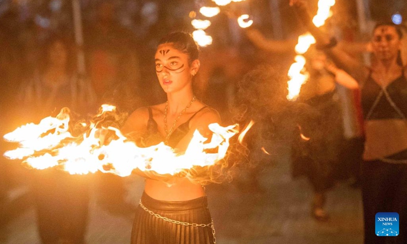 Participants play with fire sticks during the parade of Ayia Napa Medieval Festival in Ayia Napa, Cyprus, Oct. 8, 2022.(Photo: Xinhua)