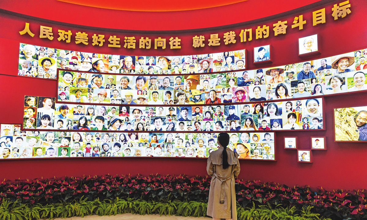 A woman visits an exhibition themed Forging Ahead in the New Era on October 2, 2022. The exhibition at the Beijing Exhibition Hall focuses on the great achievements made with the endeavor of the CPC and the country over the past decade. Photo: Li Hao/GT