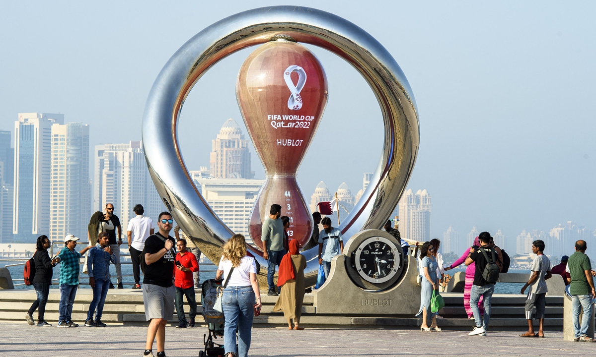 People take photos in front of the FIFA World Cup 2022 Qatar countdown clock in Doha, Qatar on October 7, 2022, ahead of the FIFA 2022 World Cup soccer competition. Photo: AFP