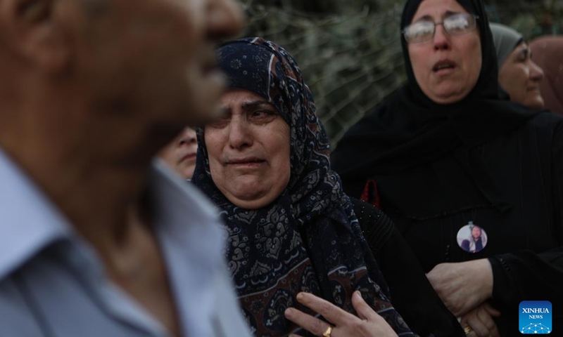 A relative of Osama Adawi, who was killed by an Israeli soldier, mourns during his funeral in the West Bank city of Hebron, Oct. 13, 2022. A Palestinian was killed and three others injured on Wednesday during clashes with the Israeli soldiers in Al-Aroub refugee camp north of the southern West Bank city of Hebron, Palestinian health authorities and eyewitnesses said.(Photo: Xinhua)