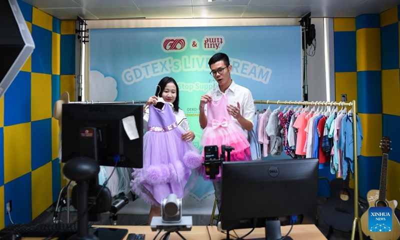 Staff members prepare a live show to be staged for the 132nd session of the China Import and Export Fair, also known as the Canton Fair, at Guangdong Textiles Import & Export Co., Ltd. in Guangzhou, south China's Guangdong Province, Oct. 14, 2022.Photo:Xinhua
