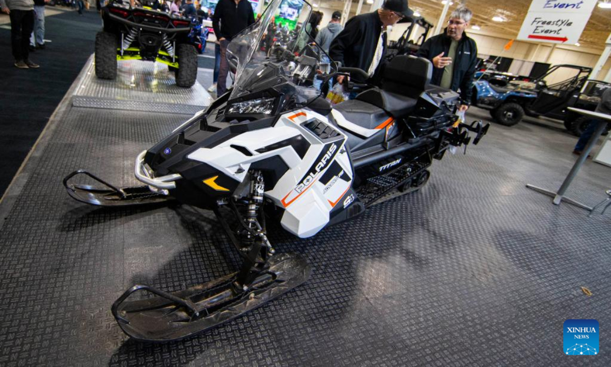 People look at a snowmobile during the 2022 Toronto International Snowmobile, ATV & Powersports Show in Mississauga, the Greater Toronto Area, Canada, on Oct 21, 2022. Showcasing hundreds of snowmobiles and all-terrain vehicles from major manufacturers across the world, the annual three-day show is scheduled to be held here from Friday to Sunday. Photo:Xinhua