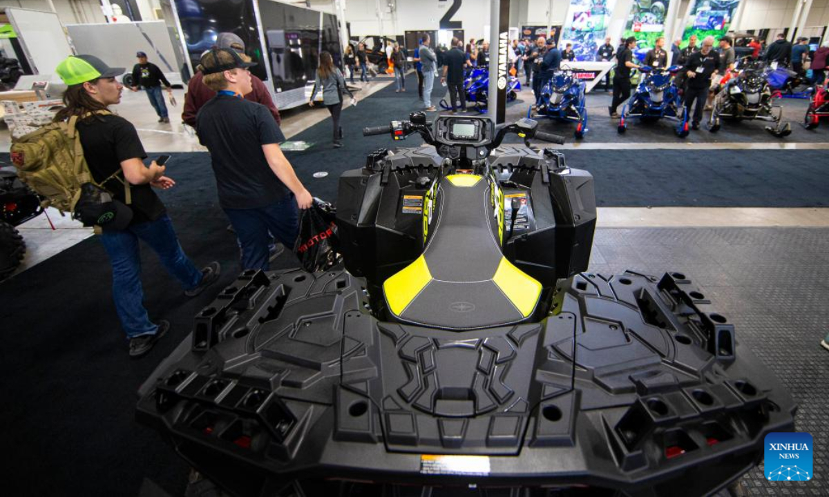 People walk past an all-terrain vehicle during the 2022 Toronto International Snowmobile, ATV & Powersports Show in Mississauga, the Greater Toronto Area, Canada, on Oct 21, 2022. Showcasing hundreds of snowmobiles and all-terrain vehicles from major manufacturers across the world, the annual three-day show is scheduled to be held here from Friday to Sunday. Photo:Xinhua