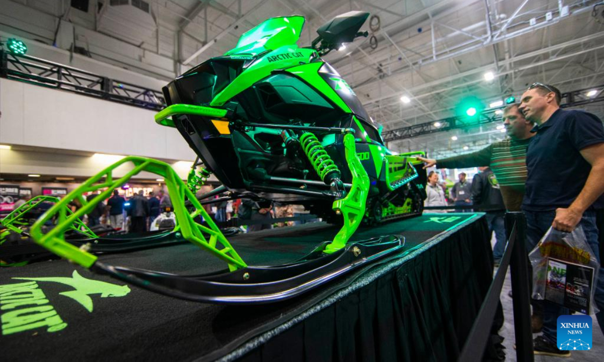 People look at a snowmobile during the 2022 Toronto International Snowmobile, ATV & Powersports Show in Mississauga, the Greater Toronto Area, Canada, on Oct 21, 2022. Showcasing hundreds of snowmobiles and all-terrain vehicles from major manufacturers across the world, the annual three-day show is scheduled to be held here from Friday to Sunday. Photo:Xinhua