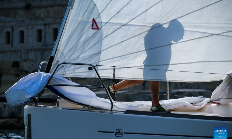A crew member prepares on the boat before the 2022 Rolex Middle Sea Race (43rd edition) at Valletta Grand Harbour in Valletta, capital of Malta, Oct. 22, 2022. Photo: Xinhua