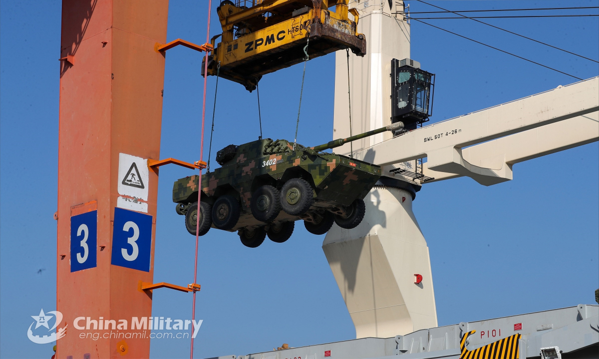 A gantry crane moves an amphibious assault vehicle attached to a brigade under the PLA 72nd Group Army into place during a load and offload exercise on September 20, 2022. Photo: China Military