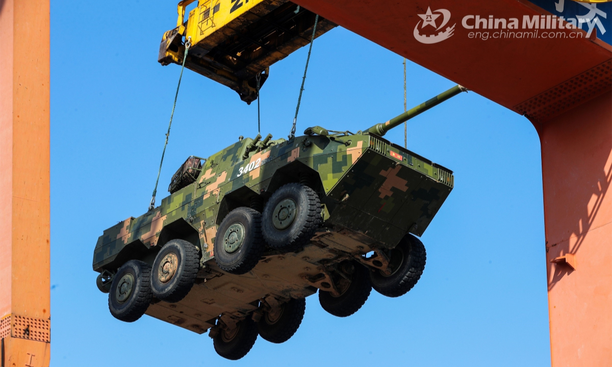 A gantry crane moves an amphibious assault vehicle attached to a brigade under the PLA 72nd Group Army into place during a load and offload exercise on September 20, 2022. Photo: China Military
