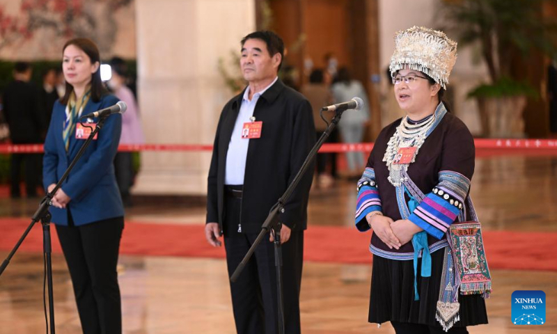 Delegates to the 20th National Congress of the Communist Party of China (CPC) Zuliyati Simayi, Ting Bater and Yang Ning (from L to R), attend an interview at the Great Hall of the People in Beijing, capital of China on October 16, 2022. Photo: Xinhua News Agency