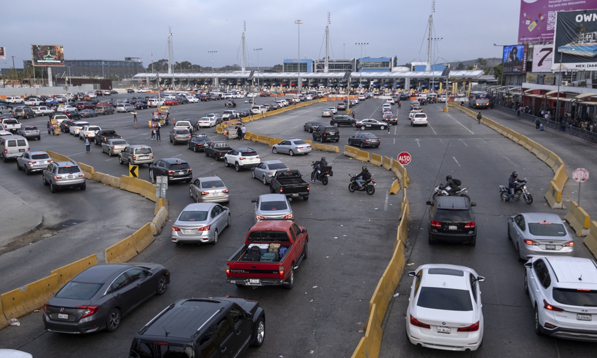 Autos hacen fila para cruzar Estados Unidos en el puerto de cruce de San Ysidro en Tijuana, estado de Baja California, México, el 4 de octubre de 2022.  Cada vez más ciudadanos estadounidenses se están mudando a México, donde encuentran la vida más barata y agradable.  Foto: AFP