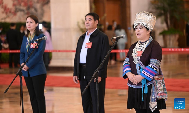 Delegates to the 20th National Congress of the Communist Party of China (CPC) Zuliyati Simayi, Ting Bater and Yang Ning (from L to R), attend an interview at the Great Hall of the People in Beijing, capital of China, Oct. 16, 2022.Photo:Xinhua