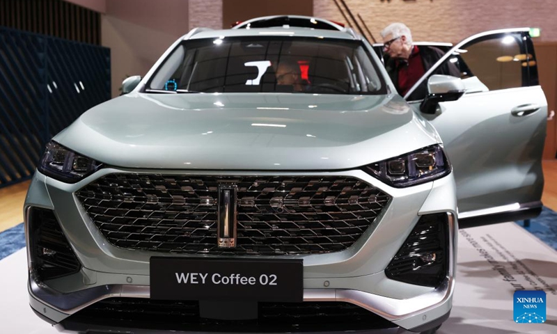 People look at a WEY Coffee 02 during the Paris Motor Show in Paris, France, Oct. 18, 2022. The 89th Paris Motor Show is held here from Oct. 17 to 23.(Photo: Xinhua)
