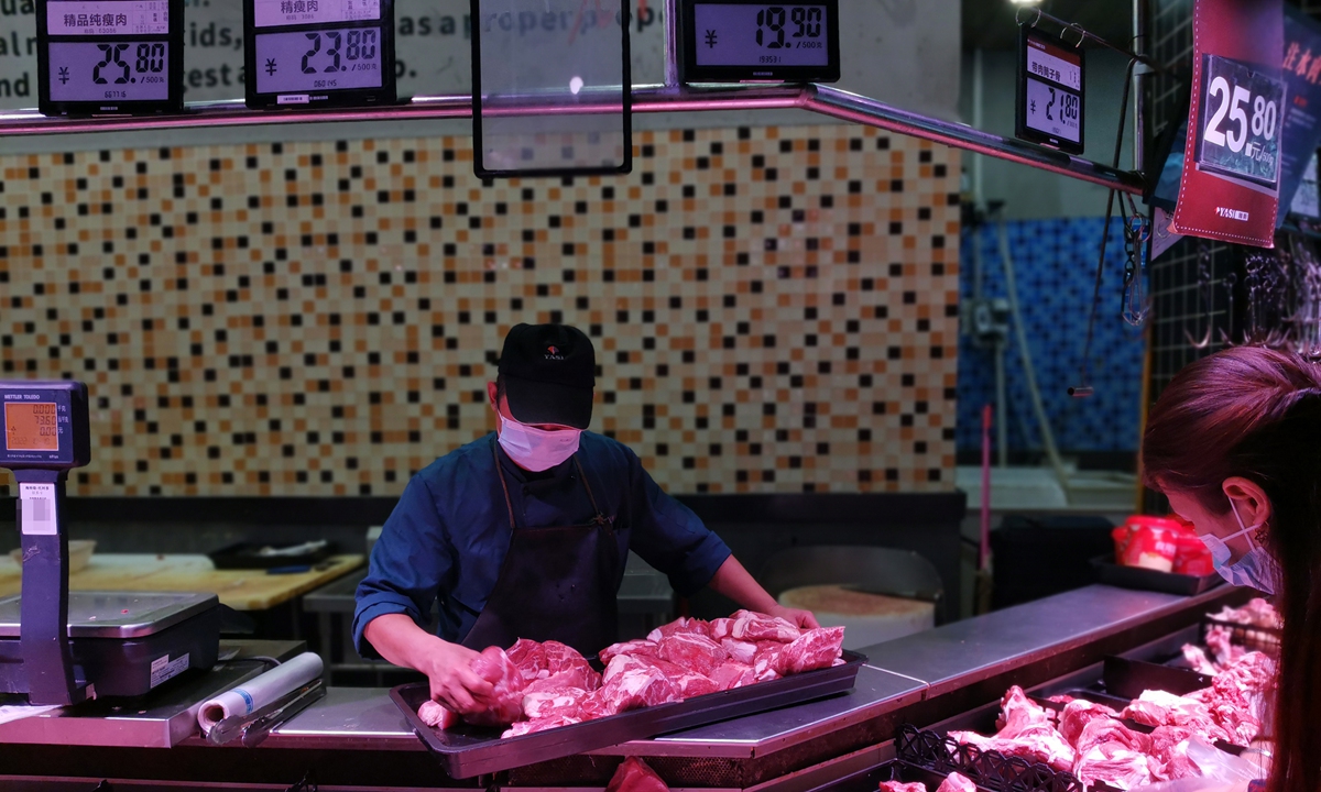 A worker puts out pork for sale at a supermarket in Yichang, Central China's Hubei Province on October 19, 2022. As pork prices are surging, China will release the sixth batch of central pork reserves this year to ensure stable pork supply, Xinhua reported on October 19. Photo: VCG
