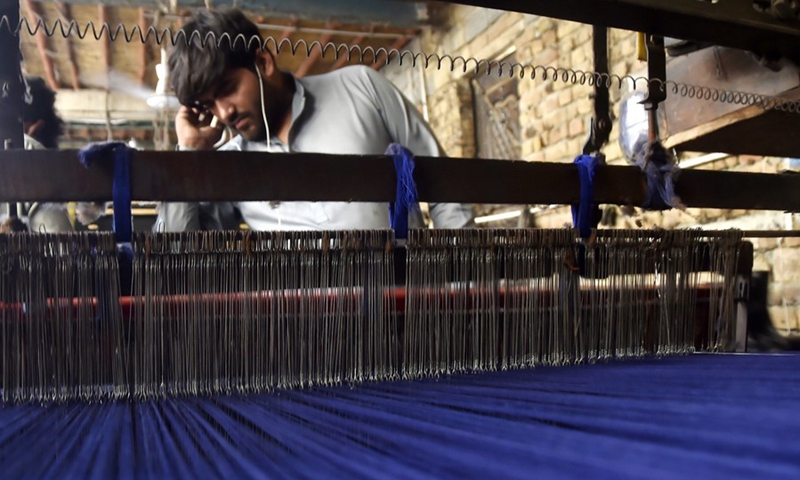 A worker works at a traditional shawl factory on the outskirts of northwest Charsadda, Pakistan, on Oct. 17, 2022.(Photo: Xinhua)
