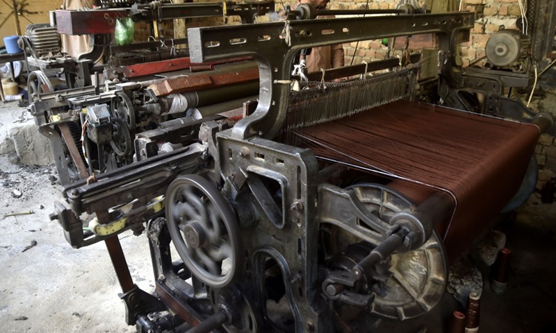 A worker works at a traditional shawl factory on the outskirts of northwest Charsadda, Pakistan, on Oct. 17, 2022.(Photo: Xinhua)