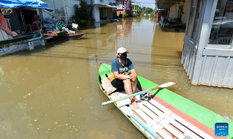 A woman sits on a boat on a flooded street in Ayutthaya, Thailand, on Oct. 18, 2022.(Photo: Xinhua)