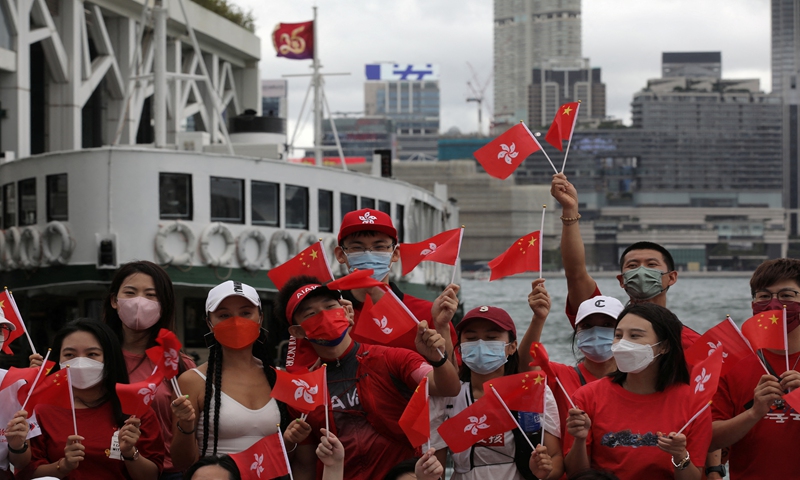 People wave the Chinese national flag and the flag of the HKSAR to celebrate the 25th anniversary of the city's return to the motherland. Photo: IC 