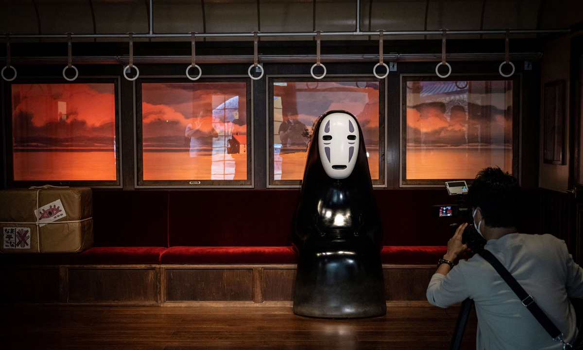 A member of the media takes a video of an exhibit at Ghibli's Grand Warehouse during a media tour of the new Ghibli Park in Nagakute, Aichi prefecture, Japan on October 12, 2022. Photo: AFP