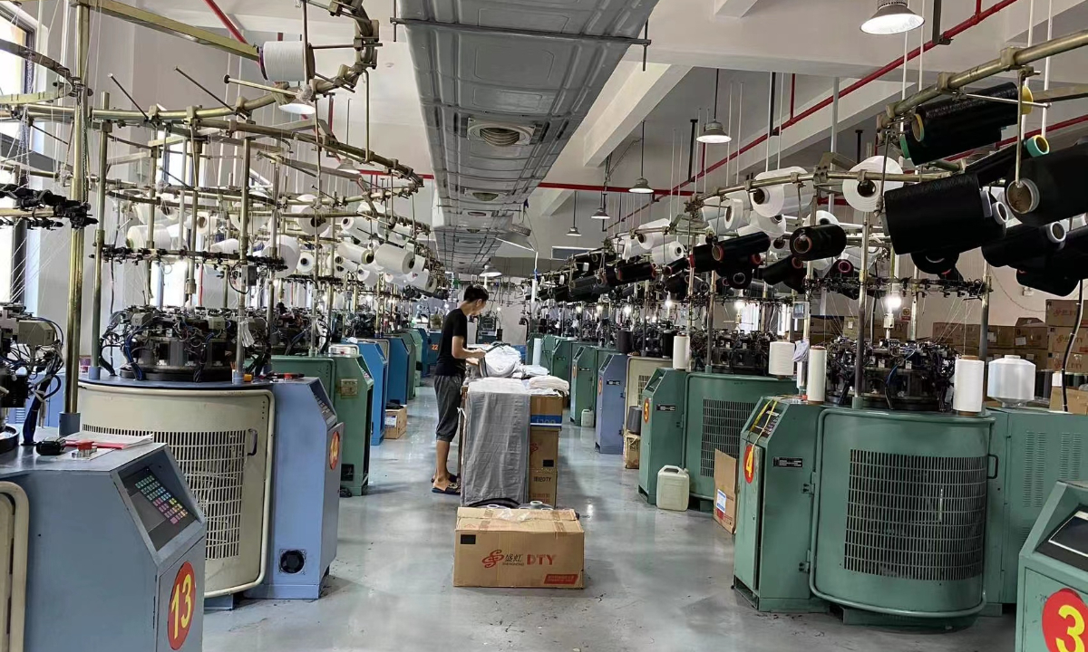 A worker check products at legging factory of Zhuji Aishanglin Knitting Co. Photo: Courtesy of Zhuji Aishanglin Knitting Co