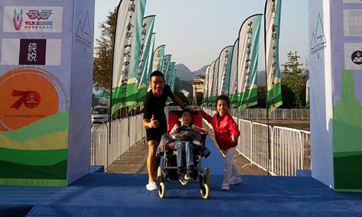 A deliveryman surnamed Luo, 46, pushes a baby stroller with his son, who has cerebral palsy, completed a half marathon in Hangzhou, East China's Zhejiang Province on Saturday.Screenshot of Phoenix Weekly