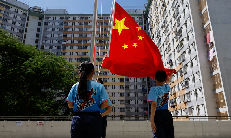 A flag raising team from a primary school perform after the first national flag raising competition in Hong Kong in September,2022.Photo:IC