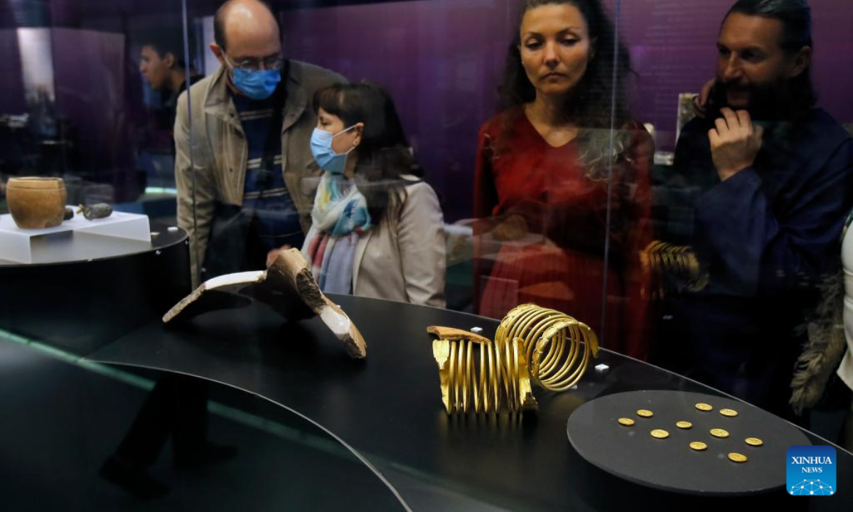 A visitor takes pictures of exhibits of the 