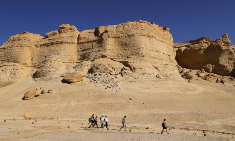 Tourists visit a wind erosional landform site in Fayoum, Egypt on Oct. 29, 2022. Photo: Xinhua