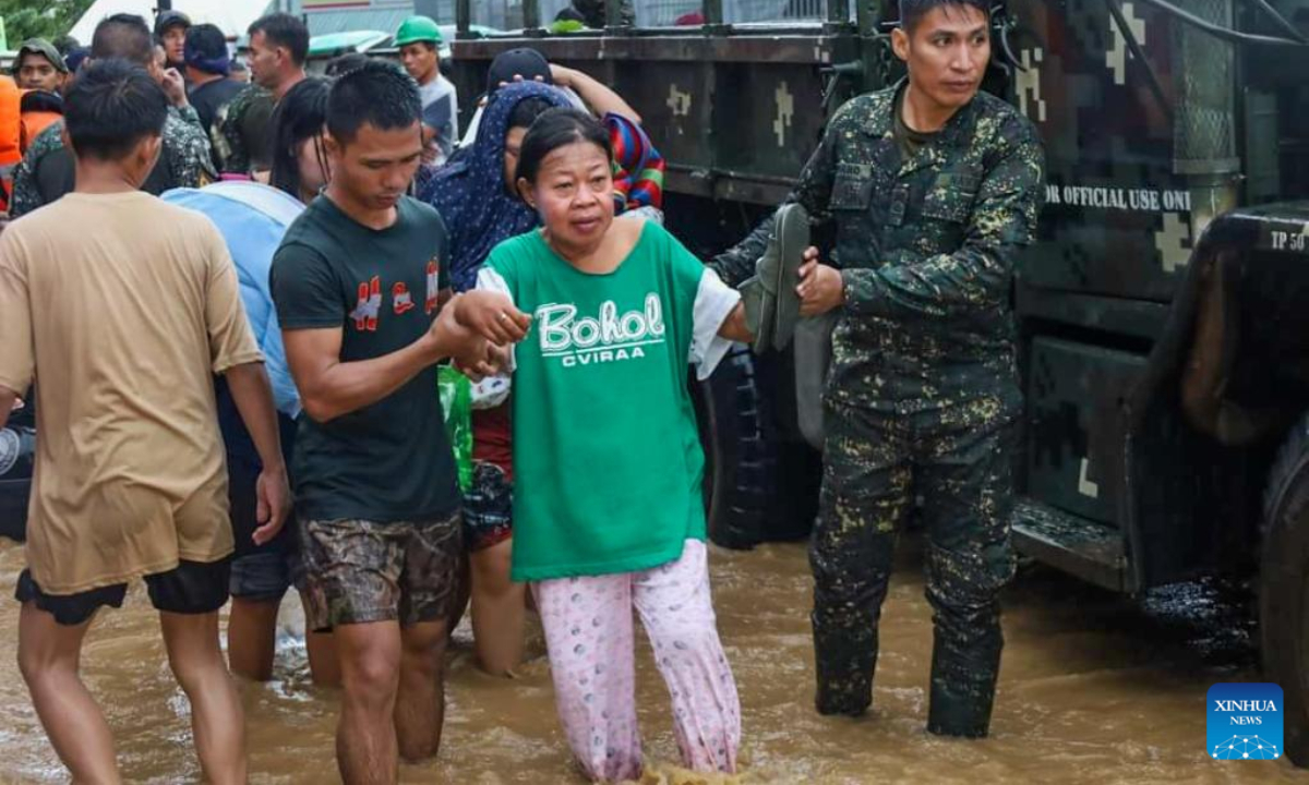 Rescuers evacuate residents affected by flood in Maguindanao Province, the Philippines, Oct 28, 2022. The death toll has risen to 42 and more people were found missing after a strong overnight downpour flooded a number of towns in the Maguindanao province in southern Philippines, a local official said Friday. Photo:Xinhua