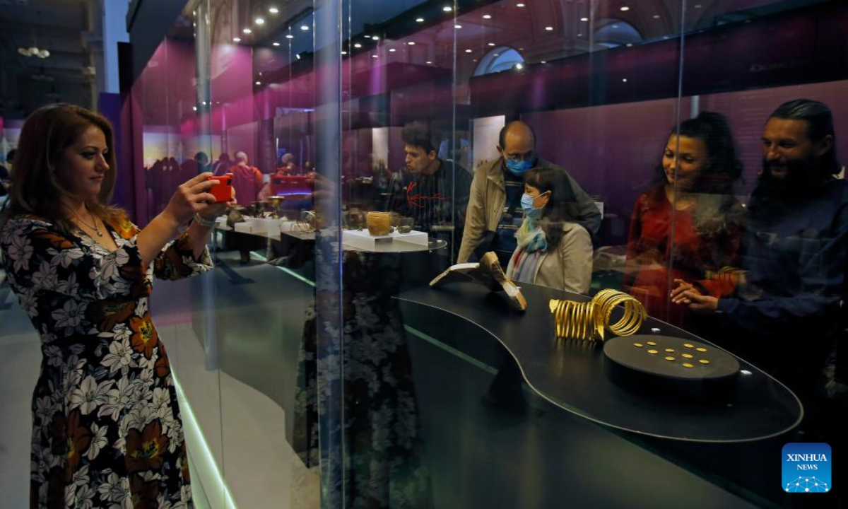 A visitor takes pictures of exhibits of the 