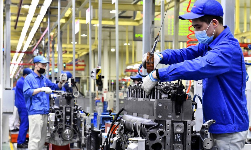 Workers assemble engines on an assembly line at a workshop of the Weichai Power Co., Ltd. in Weifang City, east China's Shandong Province, April 22, 2021. Photo: Xinhua