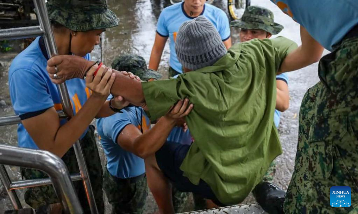 Rescuers evacuate a resident affected by flood in Maguindanao Province, the Philippines, Oct 28, 2022. The death toll has risen to 42 and more people were found missing after a strong overnight downpour flooded a number of towns in the Maguindanao province in southern Philippines, a local official said Friday. Photo:Xinhua