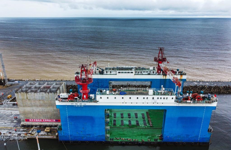 This aerial photo taken on Oct. 22, 2022 shows the caisson for the construction of phase II of Kribi Deep Seaport in Kribi, Cameroon. China Harbour Engineering Company Ltd. (CHEC) has started construction work on the second phase of the Kribi Deep Seaport in southwestern Cameroon with the installation of the first caisson that form the wharves. (Xinhua/Luo Yu)