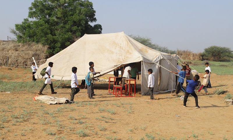 Students help to set up a tent that is used as a makeshift classroom after their school was destroyed in Hajjah province, northern Yemen, on Oct. 23, 2022.(Photo: Xinhua)