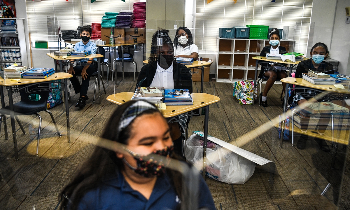 Student wear facemasks as they attend their first day in school after summer vacation at the St. Lawrence Catholic School in north of Miami, on August 18, 2021. Photo: AFP