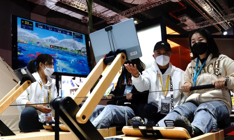 Visitors experience rowing machines at the Consumer Goods exhibition area of the fifth China International Import Expo (CIIE) at the National Exhibition and Convention Center (Shanghai) in east China's Shanghai, Nov. 5, 2022. The fifth CIIE is scheduled on Nov. 5-10 in China's economic hub Shanghai. Photo: Xinhua