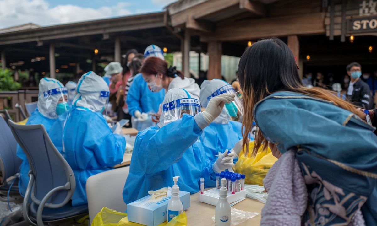Tourists take nucleic acid test in Disneyland in Shanghai on October 31, 2022. Photo: IC