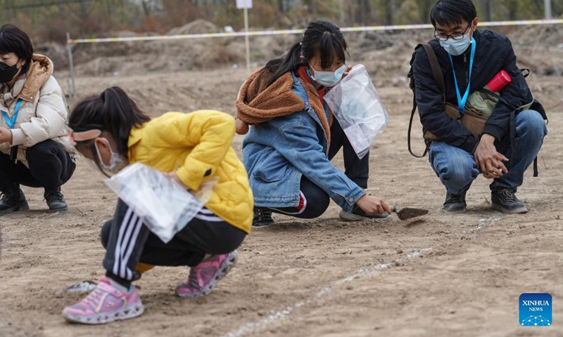 Children practice archaeological excavation work near the Liulihe relic site in Beijing, capital of China, Oct. 30, 2022. Liulihe relic site in Fangshan District of Beijing is believed to be the capital of the Yan kingdom during the Western Zhou Dynasty (1046-771 BC). As part of this year's Beijing Public Archaeology Season, a tour consisting of 20 families is organized to visit the Yan Capital Site Museum of Western Zhou Dynasty and Liulihe relic site on Sunday.(Photo: Xinhua)