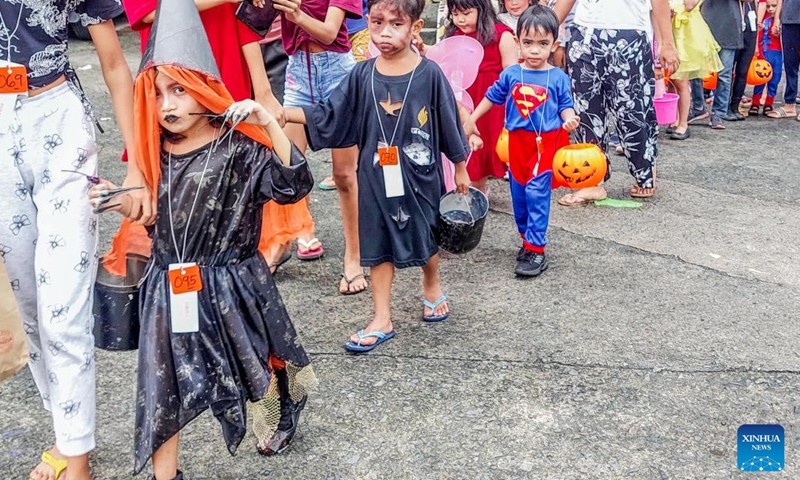 Children dressed in costumes participate in a Halloween trick or treat activity in Quezon City, the Philippines, Oct. 31, 2022.(Photo: Xinhua)