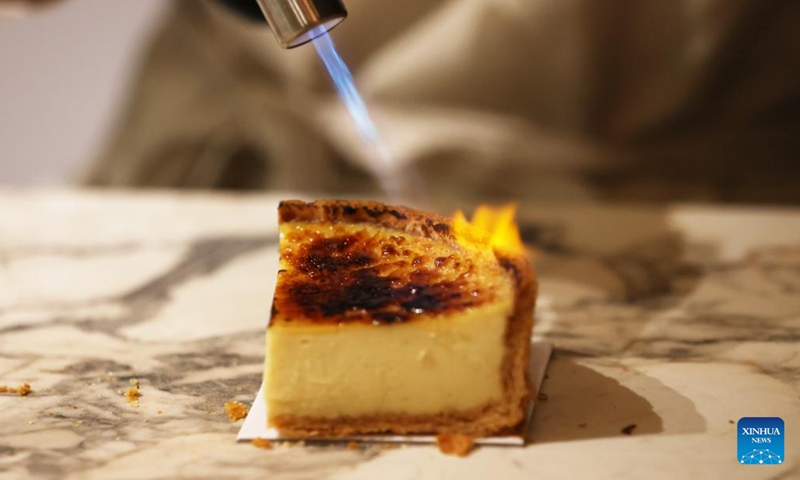 A pastry chef prepares a flan at the 27th Paris Chocolate Fair at the Versailles Expo in Paris, France, Oct. 31, 2022. The 27th Salon du Chocolat (chocolate fair) was held from Oct. 28 to Nov. 1.(Photo: Xinhua)