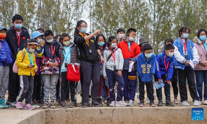 Children visit the Liulihe relic site in Beijing, capital of China, Oct. 30, 2022. Liulihe relic site in Fangshan District of Beijing is believed to be the capital of the Yan kingdom during the Western Zhou Dynasty (1046-771 BC). As part of this year's Beijing Public Archaeology Season, a tour consisting of 20 families is organized to visit the Yan Capital Site Museum of Western Zhou Dynasty and Liulihe relic site on Sunday.(Photo: Xinhua)