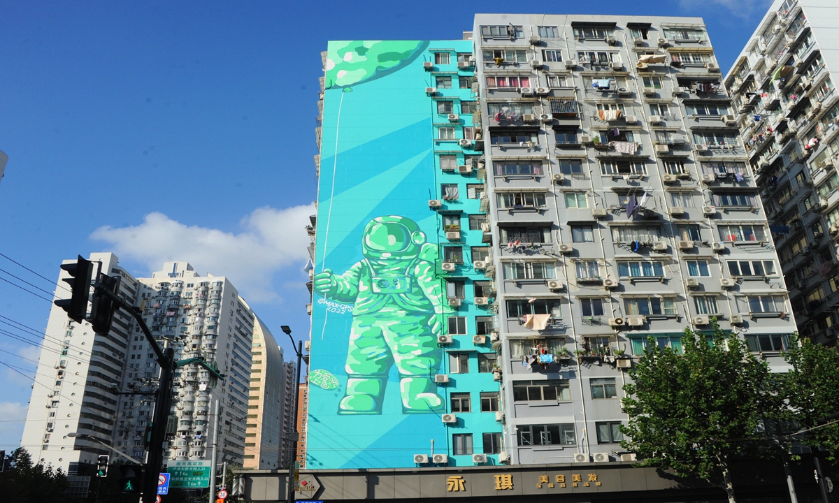 A giant painting of astronauts walking in space is seen on the wall of a residential building in Shanghai on November 1, 2022. Photo: IC